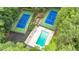 Aerial view of a pool and tennis courts surrounded by mature trees at 2911 Bentwood Dr, Marietta, GA 30062
