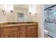 Bathroom featuring double sinks, granite countertops, wood cabinets and a tiled shower with a glass door at 2911 Bentwood Dr, Marietta, GA 30062