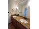 Bathroom featuring double sinks, granite countertops, wood cabinets with bronze pulls and black fixtures at 2911 Bentwood Dr, Marietta, GA 30062