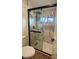 Bathroom featuring a shower with glass door and marble wall tiles and shower head with controls at 2911 Bentwood Dr, Marietta, GA 30062