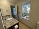 Bathroom features a granite countertop, bright window and tile floor at 2911 Bentwood Dr, Marietta, GA 30062