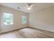 Bright bedroom featuring light wood flooring, two windows, and a ceiling fan, offering a comfortable living space at 2911 Bentwood Dr, Marietta, GA 30062