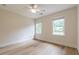 Well-lit bedroom with light wood flooring, a ceiling fan, and bright windows, creating a tranquil atmosphere at 2911 Bentwood Dr, Marietta, GA 30062