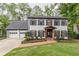 Charming two-story home with painted brick, black shutters, and a well-manicured lawn at 2911 Bentwood Dr, Marietta, GA 30062