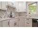 Kitchen corner features marble counters, white cabinets and a stainless steel sink, bright window at 2911 Bentwood Dr, Marietta, GA 30062