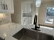 Close up of the kitchen featuring marble counter tops, white cabinets and a stainless steel sink at 2911 Bentwood Dr, Marietta, GA 30062
