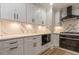 Kitchen features white cabinets, marble countertops and backsplash, stainless appliances, and wood floors at 2911 Bentwood Dr, Marietta, GA 30062