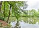 Picturesque view of the lake surrounded by lush greenery, creating a tranquil setting at 2911 Bentwood Dr, Marietta, GA 30062