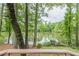 Scenic view of a tranquil lake surrounded by lush greenery from a deck at 2911 Bentwood Dr, Marietta, GA 30062