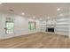 Bright living room featuring hardwood floors, a fireplace with built-in shelves, and a door to the outside at 2911 Bentwood Dr, Marietta, GA 30062