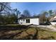 The backyard features a well-maintained lawn, a patio, and a quaint detached garage or shed at 3512 Fairlane Nw Dr, Atlanta, GA 30331