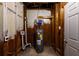A utility room shows a water heater, exposed ductwork, and unfinished walls in a basement utility area at 3512 Fairlane Nw Dr, Atlanta, GA 30331