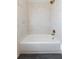 Bright bathroom features black tile floors, white marble patterned shower tiles and brass fixtures at 3512 Fairlane Nw Dr, Atlanta, GA 30331