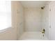 Bright bathroom features marble patterned shower tiles and brass fixtures. Includes window for light at 3512 Fairlane Nw Dr, Atlanta, GA 30331