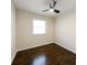 Bedroom with dark hardwood floors, a ceiling fan, and a window at 3512 Fairlane Nw Dr, Atlanta, GA 30331