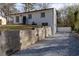 Charming home featuring a white painted brick exterior, a low retaining wall and a gravel driveway at 3512 Fairlane Nw Dr, Atlanta, GA 30331