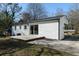 Rear exterior of home featuring a white painted brick exterior and a sliding glass door that leads to a patio at 3512 Fairlane Nw Dr, Atlanta, GA 30331