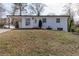 Inviting white brick home with a carport and a neatly landscaped front yard at 3512 Fairlane Nw Dr, Atlanta, GA 30331