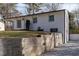 Lovely white brick home featuring a retaining wall and a tidy front yard at 3512 Fairlane Nw Dr, Atlanta, GA 30331