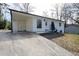 Well-kept white brick house with a long driveway and a carport at 3512 Fairlane Nw Dr, Atlanta, GA 30331