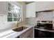 Close-up of a kitchen sink with stainless steel appliances and white backsplash at 3512 Fairlane Nw Dr, Atlanta, GA 30331