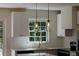 Close-up of a kitchen sink with stainless steel appliances and modern lighting at 3512 Fairlane Nw Dr, Atlanta, GA 30331