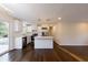 Open-concept kitchen showcasing white cabinets, stainless steel appliances, and wood floors with a view to backyard at 3512 Fairlane Nw Dr, Atlanta, GA 30331
