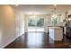 Open-concept kitchen and dining area with hardwood floors and contemporary lighting at 3512 Fairlane Nw Dr, Atlanta, GA 30331