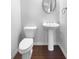 Powder room with pedestal sink, toilet, and mirror, all with neutral color palette at 362 Reserve Overlook, Canton, GA 30115