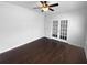 Bright bedroom featuring hardwood floors, a ceiling fan, and charming french doors at 362 Reserve Overlook, Canton, GA 30115