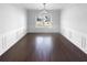 Elegant dining room with hardwood floors, wainscoting, a modern chandelier, and large windows for natural light at 362 Reserve Overlook, Canton, GA 30115