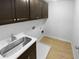 Well-equipped laundry room with sink, storage cabinets, and washer/dryer hookups at 362 Reserve Overlook, Canton, GA 30115