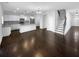 Open-concept living area with hardwood floors connecting the living room, kitchen and staircase at 362 Reserve Overlook, Canton, GA 30115