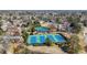 Aerial view of tennis courts surrounded by trees and houses at 540 Clubfield Drive, Roswell, GA 30075
