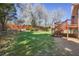Spacious backyard featuring a multilevel deck, mature trees, and lush green grass at 540 Clubfield Drive, Roswell, GA 30075
