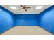 Finished basement with blue walls and ceiling fan at 540 Clubfield Drive, Roswell, GA 30075