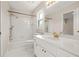 Bathroom showcasing a tub with shower, vanity with sink, and classic white tile at 540 Clubfield Drive, Roswell, GA 30075