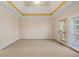 Spacious bedroom featuring tray ceiling and neutral carpeting at 540 Clubfield Drive, Roswell, GA 30075