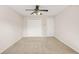 Neutral bedroom with carpeted floors, a ceiling fan, and double door closet at 540 Clubfield Drive, Roswell, GA 30075