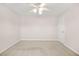 Empty bedroom featuring neutral walls, carpeted floors, and a ceiling fan at 540 Clubfield Drive, Roswell, GA 30075