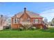 Back exterior of house featuring a brown exterior, lush green lawn, and spacious deck at 540 Clubfield Drive, Roswell, GA 30075
