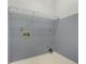 Functional laundry room featuring grey walls and a wire rack for storage at 540 Clubfield Drive, Roswell, GA 30075