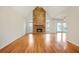 Spacious living room featuring hardwood floors, a stone fireplace, and plenty of natural light at 540 Clubfield Drive, Roswell, GA 30075