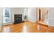 Bright and inviting living room with a fireplace, hardwood floors, staircase, and large windows at 540 Clubfield Drive, Roswell, GA 30075