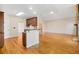 Spacious open-concept with stone fireplace, kitchen bar, and hardwood floors at 540 Clubfield Drive, Roswell, GA 30075
