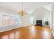 Bright living room with hardwood floors, fireplace, and a grand chandelier at 540 Clubfield Drive, Roswell, GA 30075