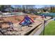 Community playground with slides, swings, and climbing structures, surrounded by mature trees and green space at 540 Clubfield Drive, Roswell, GA 30075