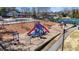 Community playground with slides, swings, and climbing structures, surrounded by mature trees and green space at 540 Clubfield Drive, Roswell, GA 30075