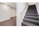 Basement stairs with grey carpet and white handrail at 540 Clubfield Drive, Roswell, GA 30075