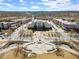 An aerial view showcases a traditional city hall surrounded by shops and green spaces at 4000 Bethelview Ln, Suwanee, GA 30024